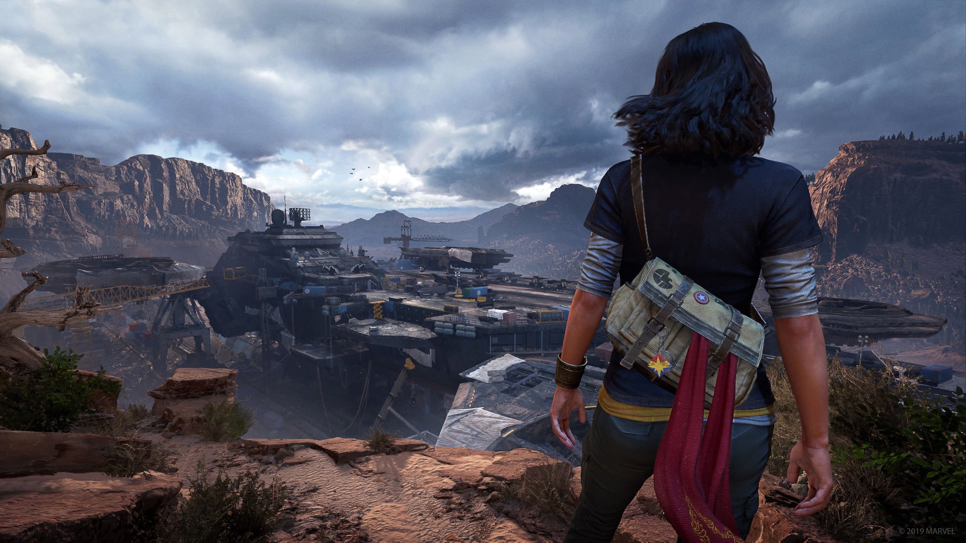 Image from a game; a character overlooking a city in the mountains in the distance