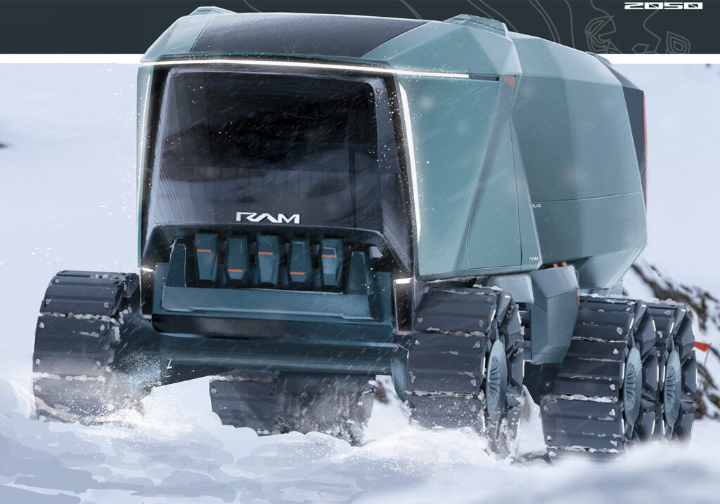 A close-up, front-facing view of a large, rugged, dark teal-colored vehicle with tank-like tracks instead of wheels. The front has a wide, clear windshield and the "RAM" logo. The vehicle appears to be moving through a snowy or icy landscape, with snow splashing up from its tracks.